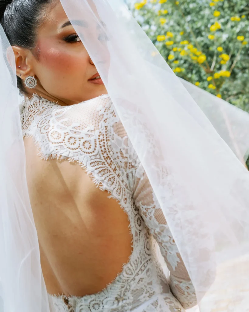 Bride in a lace gown and veil, seen from behind